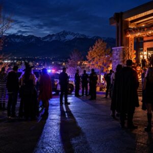 Police officers speak with costumed guests outside a Colorado Springs Halloween party.